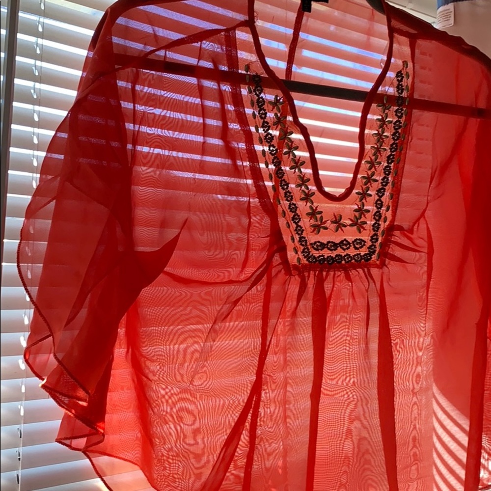 Orange sheer top.